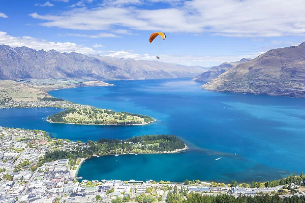 Aerial view of Queenstown, paraglider, Lake Wakatipu and The Remarkables mountains