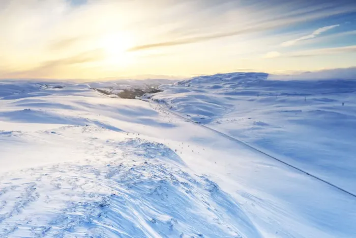 Framed Print : Aerial view of empty road across mountains covered with snow lit by sunrise, Sennalandet Framed Print : Aerial view of empty road across mountains covered with snow lit by sunrise, Sennalandet