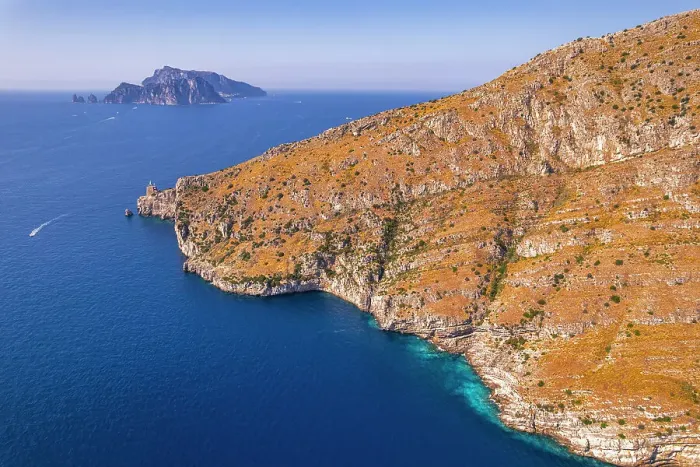 Framed Print : Aerial view of a rocky coast facing the blue water of the Tyrrhenian Sea with the island of Capri in the background, Amalfi Coast, Naples province, Campania region, South of Italy, Italy, Europe Framed Print : Aerial view of a rocky coast facing the blue water of the Tyrrhenian Sea with the island of Capri in the background, Amalfi Coast, Naples province, Campania region, South of Italy, Italy, Europe
