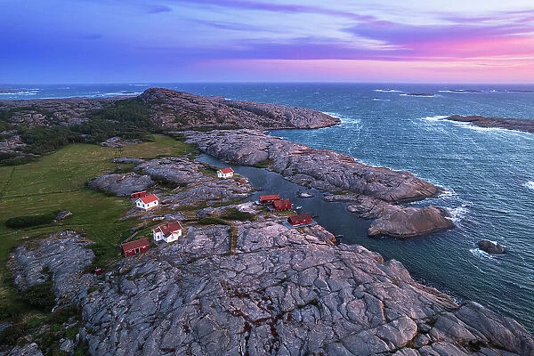 Aerial view of the scenic landscape of granite rocks with isolated houses and red cottages along the shore, Ramsvik island, Bohuslan, Vastra Gotaland, West Sweden, Sweden, Scandinavia, Europe