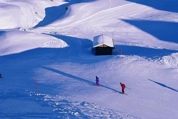 Aerial view of skiers and alpine hut