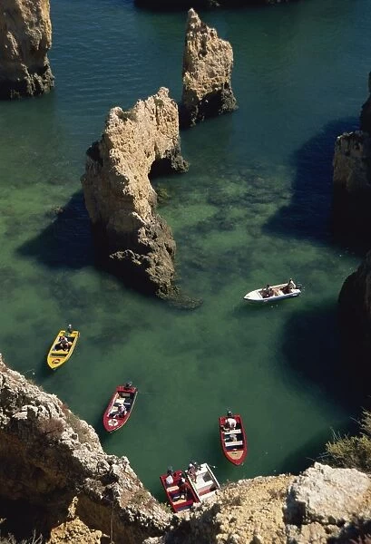 Aerial view of small boats in the sea alongside sea