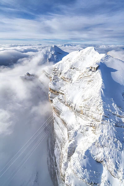 Aerial view of snow capped Tofane group and scenic Freccia nel Cielo cableway, Dolomites