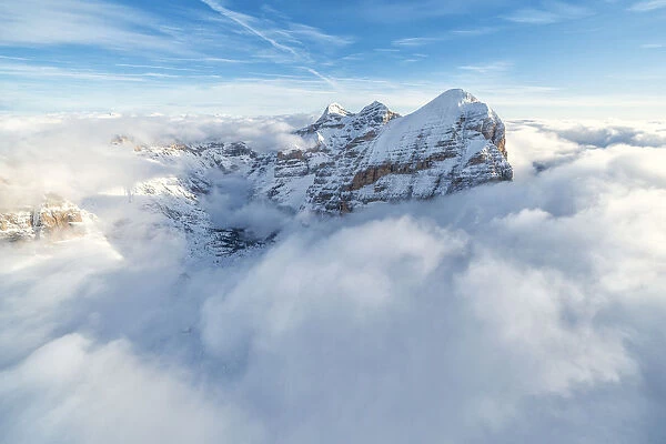 Aerial view of the snow capped Tofane group in a sea of clouds, Dolomites