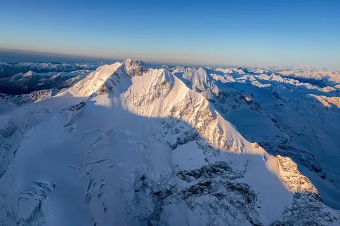 Framed Print : Aerial view of the snow covered Piz Bernina and Biancograt mountains at dawn, Engadine
