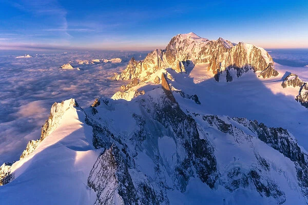 Aerial view of snowy peaks of Mont Blanc and Dent du Geant during sunrise, Courmayeur