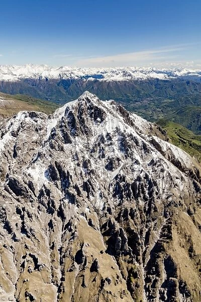Aerial view of the snowy ridges of the Grignetta mountain in spring, Lecco Province