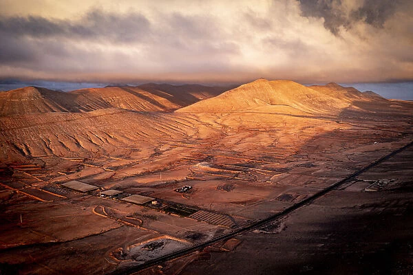 Aerial view of sunrise over the dry desert land of Caldereta, Vallebron, La Oliva