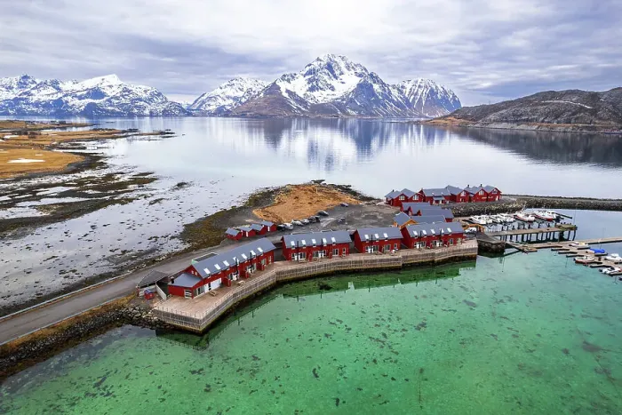 Framed Print : Aerial view of traditional red rorbu surrounded by majestic mountains covered with snow, Vestvagoy, Lofoten Islands, Norway, Scandinavia, Europe