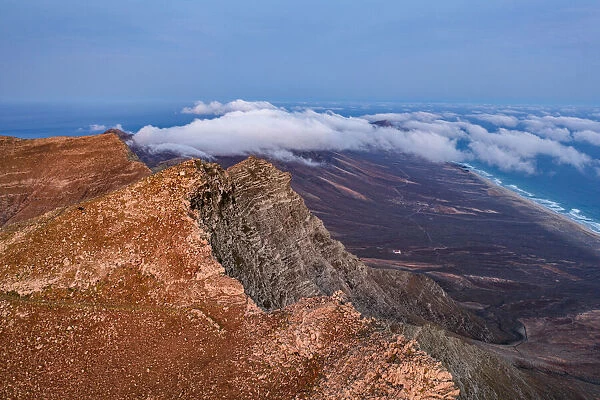 Aerial view of volcanic rocks of Pico de la Zarza mountain peak during a misty sunrise, Fuerteventura, Canary Islands, Spain, Atlantic, Europe