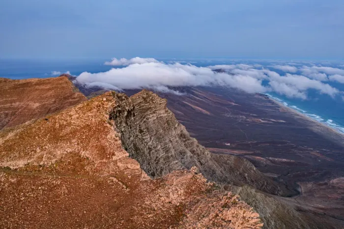 Framed Print : Aerial view of volcanic rocks of Pico de la Zarza mountain peak during a misty sunrise, Fuerteventura, Canary Islands, Spain, Atlantic, Europe Framed Print : Aerial view of volcanic rocks of Pico de la Zarza mountain peak during a misty sunrise, Fuerteventura, Canary Islands, Spain, Atlantic, Europe