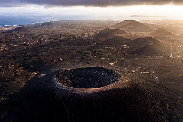 Aerial view of volcanoes and craters with the Atlantic Ocean in the background, Corralejo