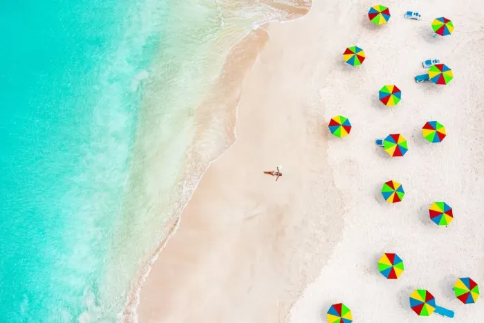 Framed Print : Aerial view of woman in bikini sunbathing on a tropical beach next to colorful umbrellas, Antigua, West Indies, Caribbean, Central America Framed Print : Aerial view of woman in bikini sunbathing on a tropical beach next to colorful umbrellas, Antigua, West Indies, Caribbean, Central America