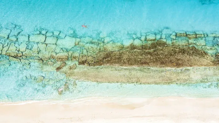 Framed Print : Aerial view of woman floating on the crystal sea in between coral reef and white sand beach, Antigua, West Indies, Caribbean, Central America Framed Print : Aerial view of woman floating on the crystal sea in between coral reef and white sand beach, Antigua, West Indies, Caribbean, Central America