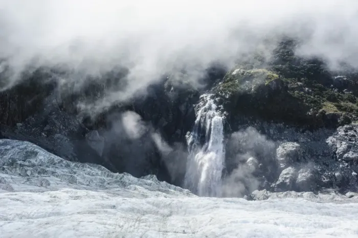 Framed Print : Aerial of a waterfall flowing into the icefield of Fox Glacier, Westland Tai Poutini National Park, South Island, New Zealand, Pacific Framed Print : Aerial of a waterfall flowing into the icefield of Fox Glacier, Westland Tai Poutini National Park, South Island, New Zealand, Pacific
