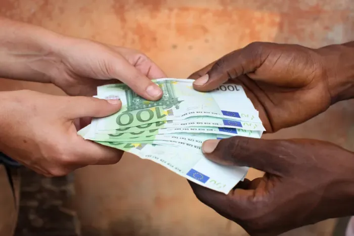 Framed Print : African holding Euros, Lome, Togo, West Africa, Africa