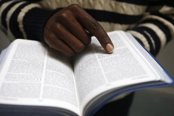 African man reading the Bible in a church, Paris, France, Europe