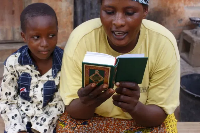 Framed Print : African mother reading the Koran, Lome, Togo, West Africa, Africa Framed Print : African mother reading the Koran, Lome, Togo, West Africa, Africa