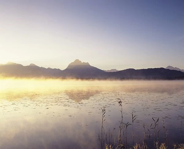 Allgau Alps reflecting in Hopfensee Lake at sunrise, near Fussen, Allgau, Bavaria, Germany, Europe