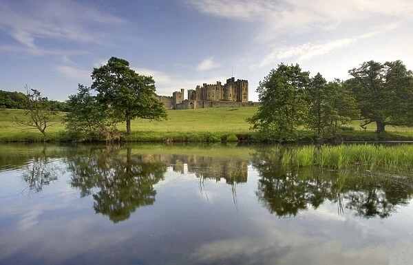 Alnwick Castle reflecting in River Aln, Alnwick, Northumberland, England