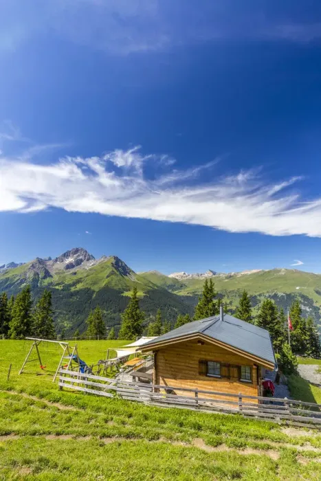 Framed Print : Alpine hut with Swiss flag, beneath stunning clouds. Surses, Surselva, Graubunden Framed Print : Alpine hut with Swiss flag, beneath stunning clouds. Surses, Surselva, Graubunden