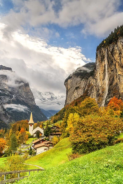 Alpine village of Lauterbrunnen and Trummelbach Falls cascade in autumn, canton of Bern