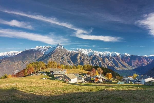 Amazing clouds above a traditional mountain village, Valchiavenna, Lombardy, Italy