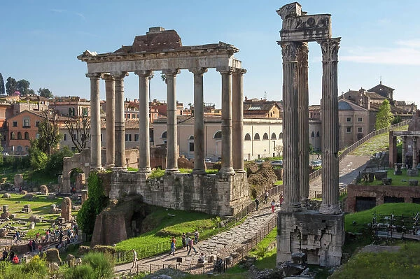Ancient Roman Road traverses the columns and ruins in the Forum of Ancient Rome