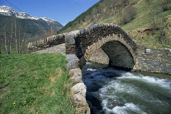 Ancient stone bridge over a river in the La Malana district in the Pyrenees in Andorra