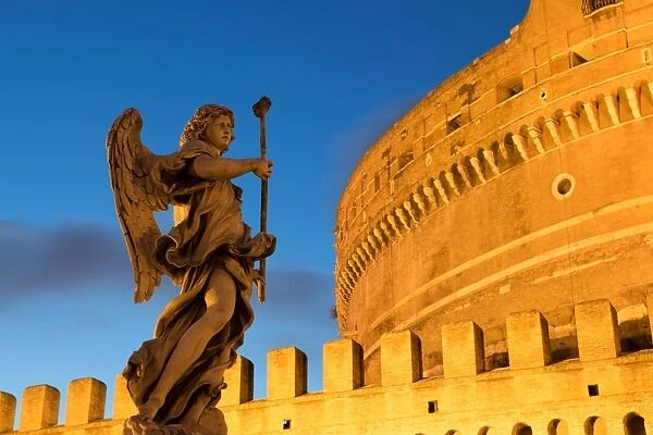 Angel statue on Ponte Sant Angelo bridge at dusk with Castel Sant Angelo, Rome, Lazio, Italy, Europe