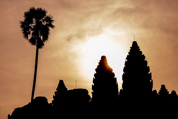 Angkor archaeological complex silhouetted against the rising sun, Angkor