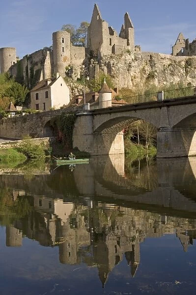An angler on the Anglin river, with the medieval castle built between the 11th