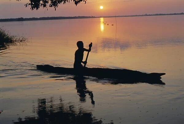 Anouak man in canoe, Lake Tata, Ethiopia, Africa