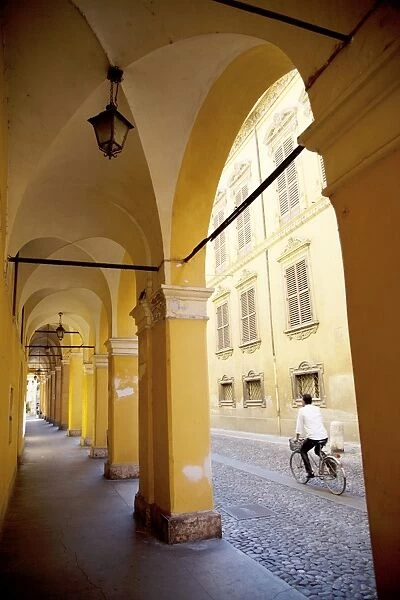 Arcade and cyclist, Modena, Emilia Romagna, Italy, Europe