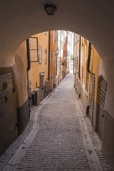 Arch and cobblestone alley in historic Gamla Stan, Stockholm, Sweden, Scandinavia, Europe