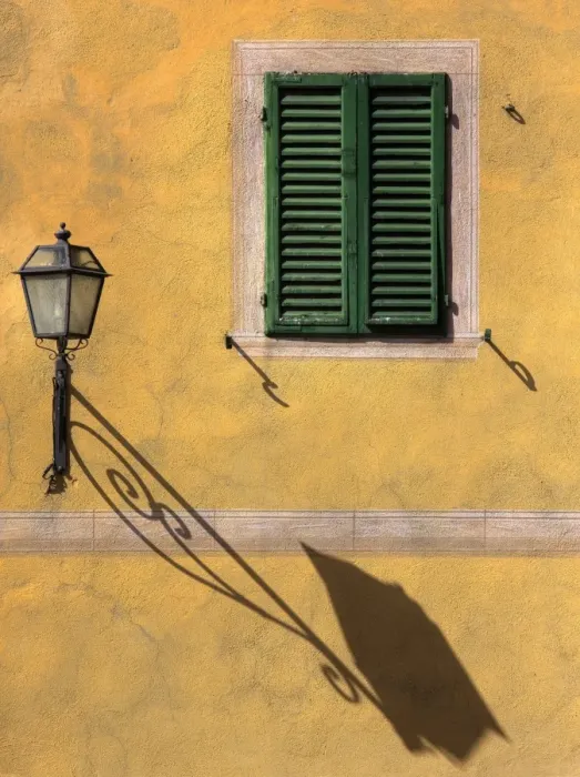 Framed Print : Architectural detail showing green wooden shutter on yellow wall with ornate wall lamp Framed Print : Architectural detail showing green wooden shutter on yellow wall with ornate wall lamp