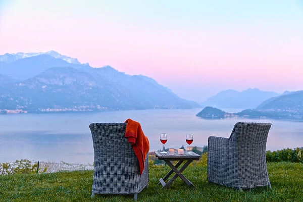 Armchairs and red wine with views of Lake Como at sunset, Lombardy, Italian Lakes
