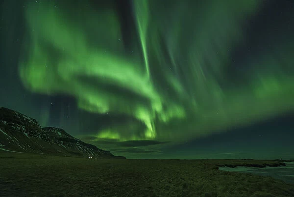 Aurora borealis (Northern Lights) and partially frozen lake, North Snaefellsnes, Iceland