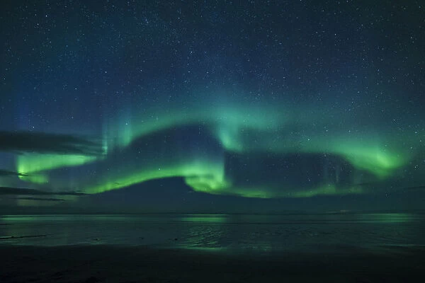 Aurora borealis (Northern Lights) reflected in ocean, North Snaefellsnes, Iceland