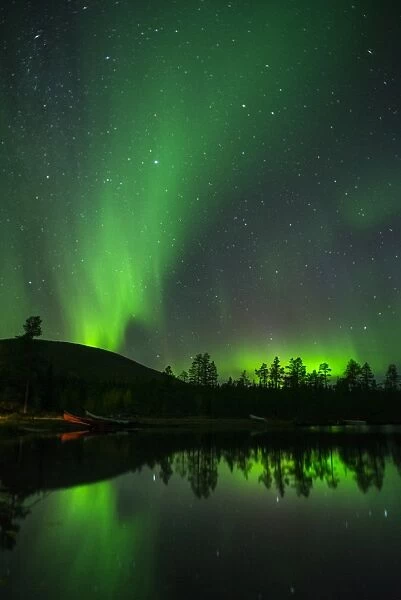Aurora Borealis and stars over lake at night, Muonio, Lapland, Finland, Scandinavia