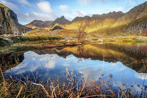 Autumn colors over mountains reflected in the sea, A i Lofoten, Moskenes, Lofoten Islands, Nordland, Norway, Scandinavia, Europe