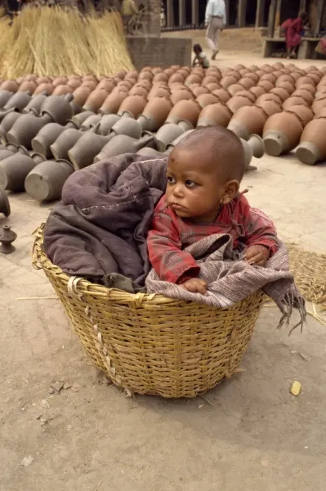 Framed Print : Baby in a wicker basket at Bhaktapur in Nepal Framed Print : Baby in a wicker basket at Bhaktapur in Nepal