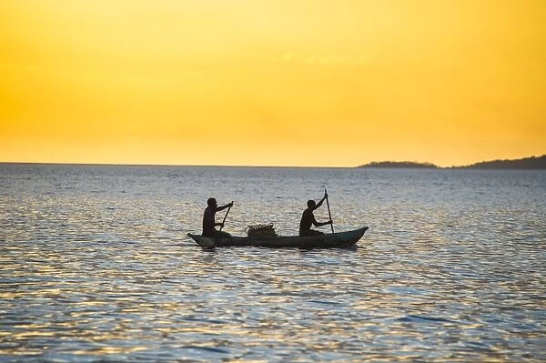 Backlight of fishermen in a little fishing boat at sunset, Lake Malawi, Cape Maclear