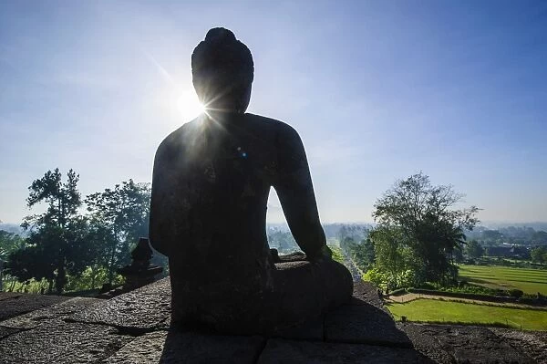 Backlight of a sitting Buddha in the temple complex of Borobodur, UNESCO World Heritage Site, Java, Indonesia, Southeast Asia, Asia
