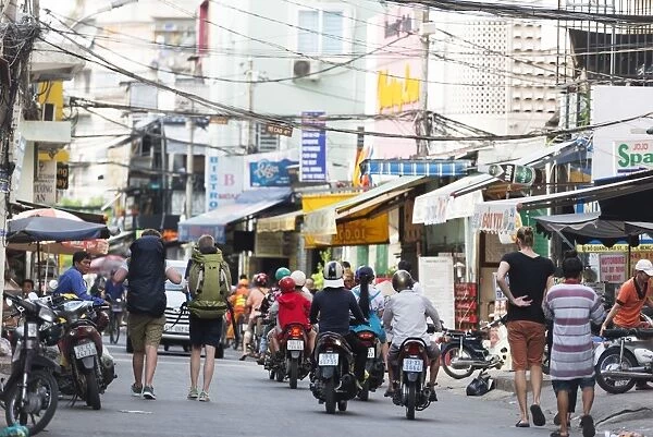 Backpackers on city street, Ho Chi Minh City (Saigon), Vietnam, Indochina, Southeast Asia