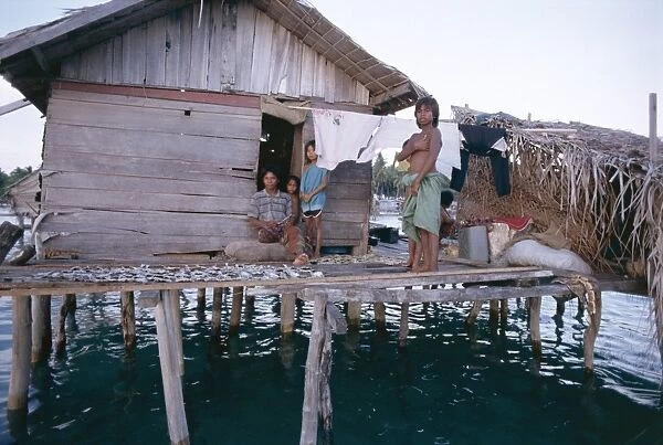 Bajau family in stilt house over the sea