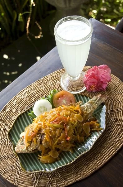 Baked fish Balinese style with a fresh lemon drink, Ubud, Bali, Indonesia