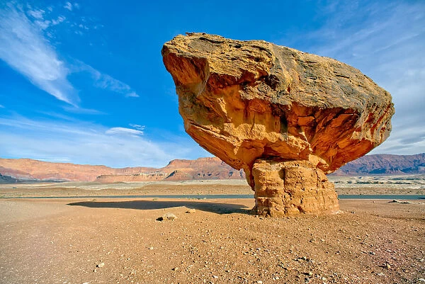 Balanced boulder at the base of Vermilion Cliffs in Glen Canyon Recreation Area, Arizona