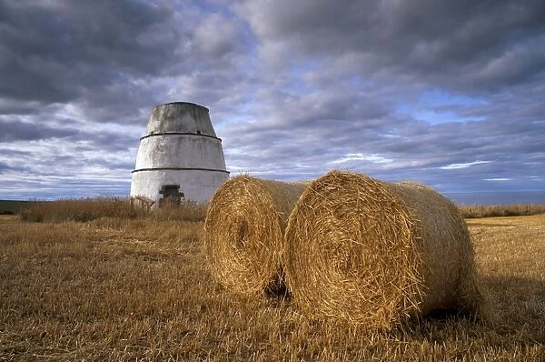 Bales of straw and old dovecote