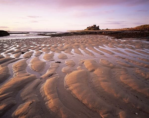 Bamburgh castle and Bamburgh beach at sunrise, Bamburgh, Northumberland